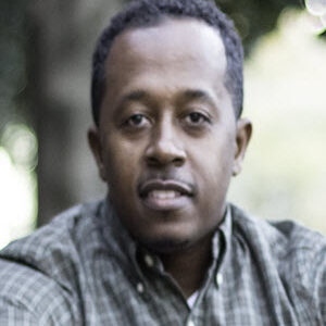 black male with tan plaid shirt