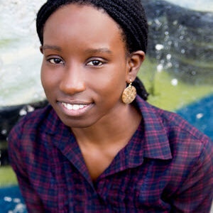 black women with smile, blue and red plaid shirt