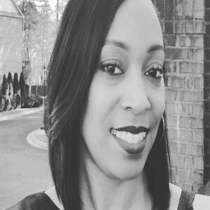 black woman with smile and brick background